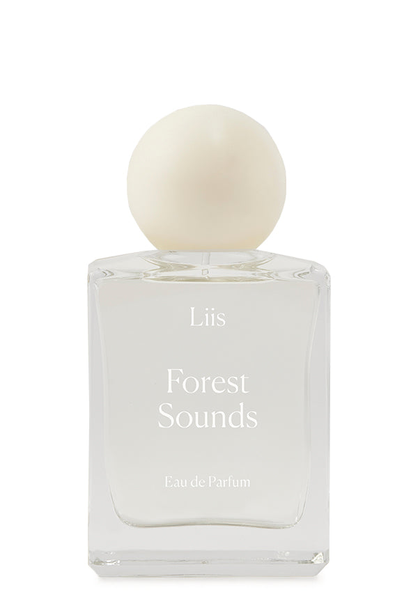Clear glass bottle of Forest Sounds fragrance by Liis with a round, white cap on a white background.